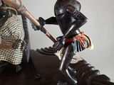 a statue of a man holding a baseball bat on a table