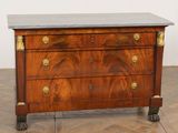 an antique chest of drawers with marble top and brass handles