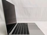 a laptop computer that is sitting on a white surface