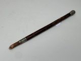 a close up of a wooden stick on a white surface