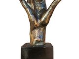 a close up of a bronze statue of a hand on a black base