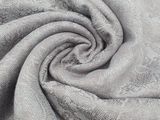 a close up of a gray fabric with a pattern on it