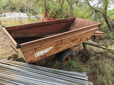 a small wooden cart that is sitting in the grass