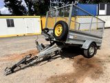 a trailer with a trailer attached to it in a parking lot