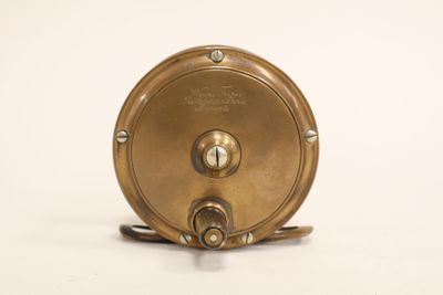 a small brass object on a white surface