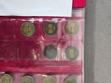 a lot of coins that are in a plastic case