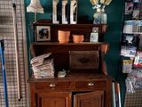 a wooden cabinet in the corner of a room