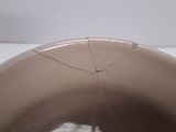 a brown bowl with a crack in the middle of it