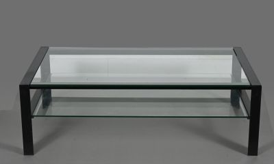 a glass coffee table with black legs and a glass top