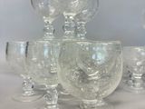 a lot of wine glasses sitting on a table