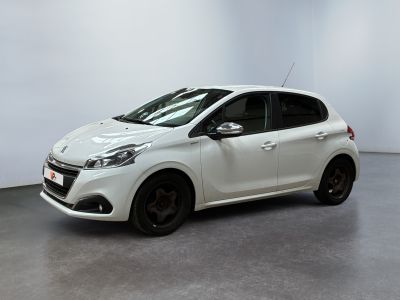 the white car is parked in a room with a white wall