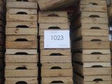 many wooden crates stacked on a shelf in a store