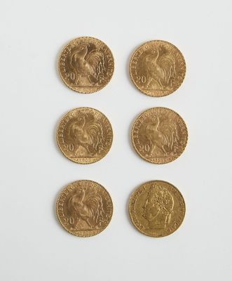 six souverains en or de tailles et de formes différentes sur une surface blanche