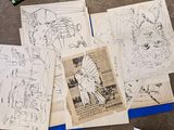 a bunch of drawings on a table next to a pair of scissors and a pair of scissors