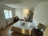 a bedroom with a bed and a bookshelf in it