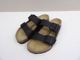 black birketts sandals on a white surface