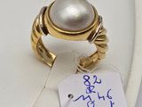 a ring with a pearl on it and a price tag attached to it