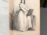 an open book with a picture of a woman in a white dress