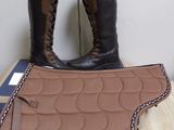 a pair of boots and a saddle pad on a table