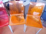 three plastic chairs that are sitting next to each other