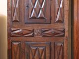 a wooden cabinet with a mirror on top of it