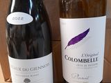 two bottles of wine sitting next to each other on a table