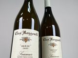 two bottles of wine sitting next to each other on a table