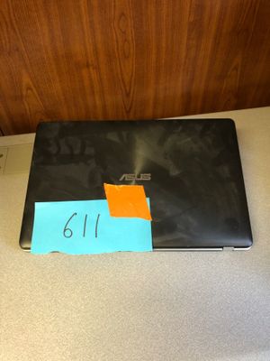 a laptop with a sticky note on it sitting on a counter