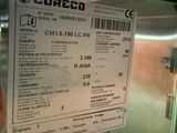 a person holding a ticket in front of a freezer