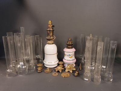 a lot of glass vases and a lamp on the table