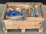 une boîte en bois contenant un tas de tiges métalliques