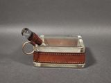 a small glass box with a keychain on top of it