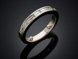 a close up of a wedding ring on a black surface
