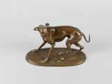 an image of a bronze statue of a dog running with a ball