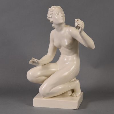 statue of a woman sitting on a marble base with her hands in her pockets