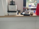 a picture of a desk with a printer and a trash can