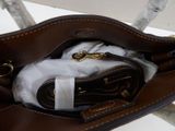 a purse with a pair of scissors inside of it