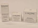 three boxes of lancomme skin care products on a white surface