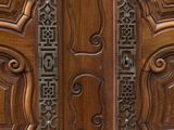 a close up of a wooden door with carvings on it
