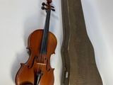 a violin and a case on a white surface