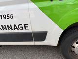 a green and white van parked on the side of the road