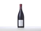 a bottle of red wine sitting on top of a table