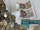 a pile of money and a bunch of coins on a table
