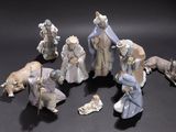 many figurines of people and animals on a black surface