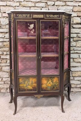 a small cabinet with a glass door on top of it