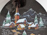 a decorative plate with a church in the middle of it