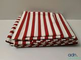 three red and white striped napkins stacked on top of each other
