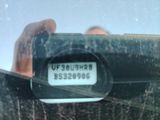 a person taking a picture of a clock in a mirror