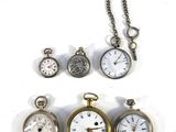 many different types of pocket watches displayed on a white surface