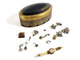 a small box with a lot of jewelry on it